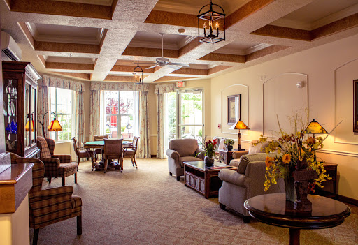 A cozy and inviting living room featuring elegant furniture, wooden beams, and ample natural light.