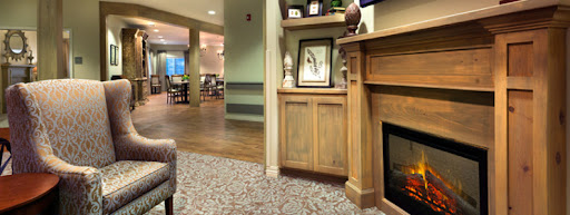A cozy interior scene featuring a wooden cabinet and decorative elements, inviting a warm atmosphere.