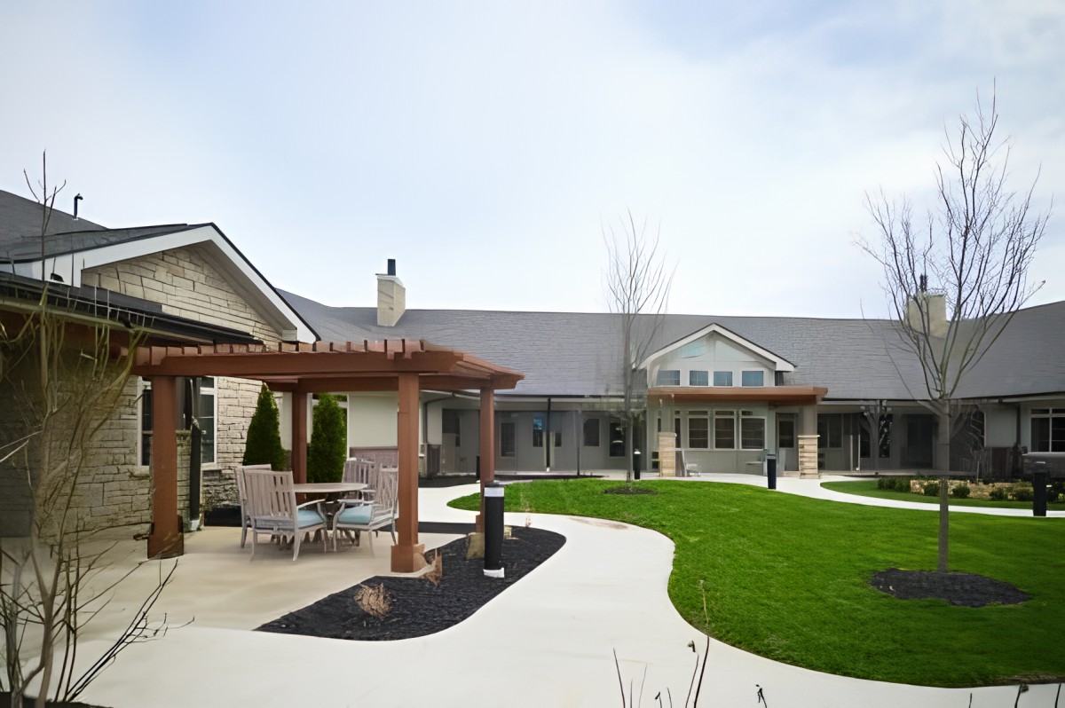A view of a modern building with a landscaped garden and walkways.