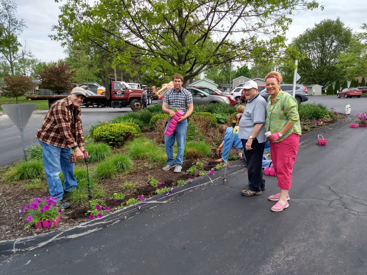A group of people gardening together in a community space.