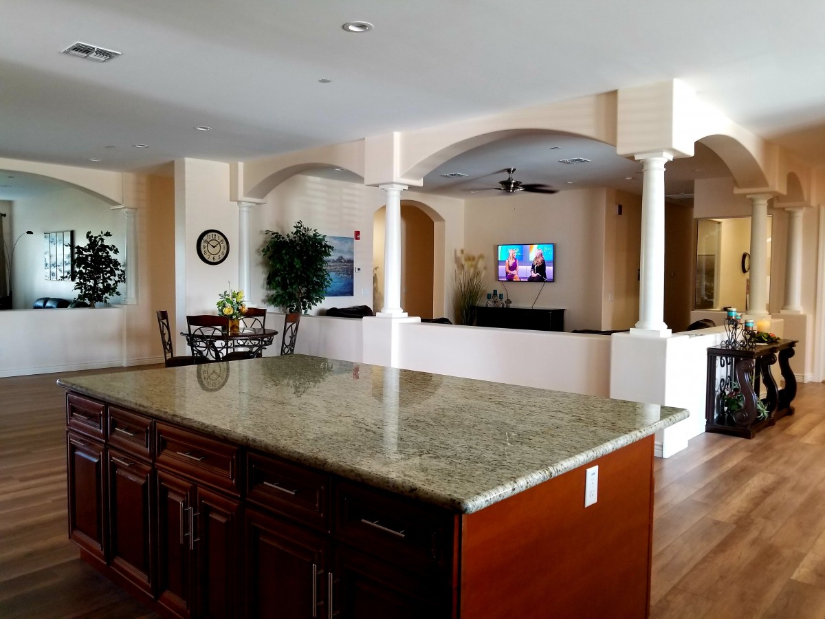 Spacious open floor plan featuring a kitchen island and cozy living area.