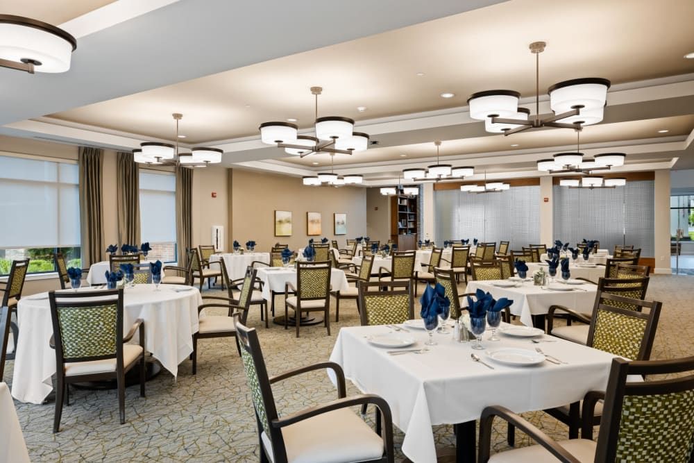 An elegantly designed dining area with neatly arranged tables and stylish lighting.