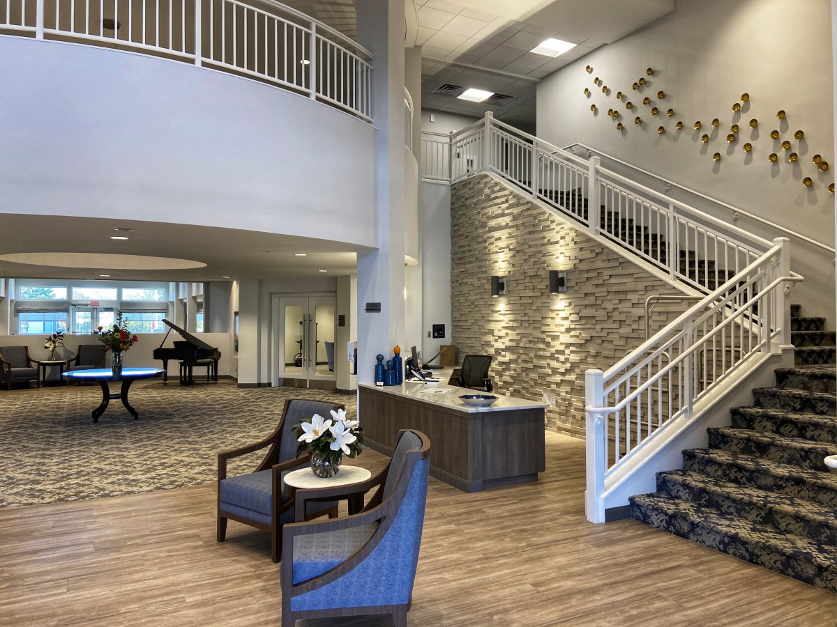 Modern interior lobby with seating and reception desk.