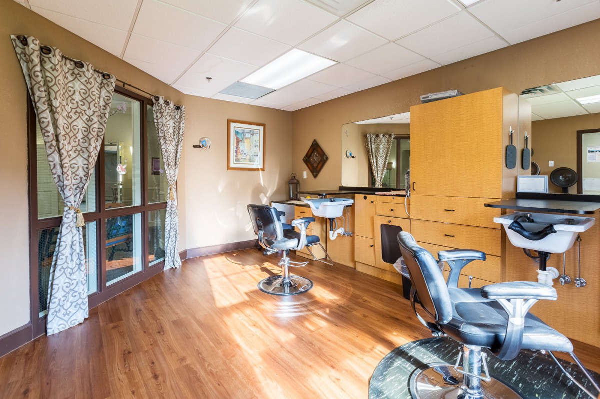 A bright and modern hair salon interior with styling chairs and mirrors.