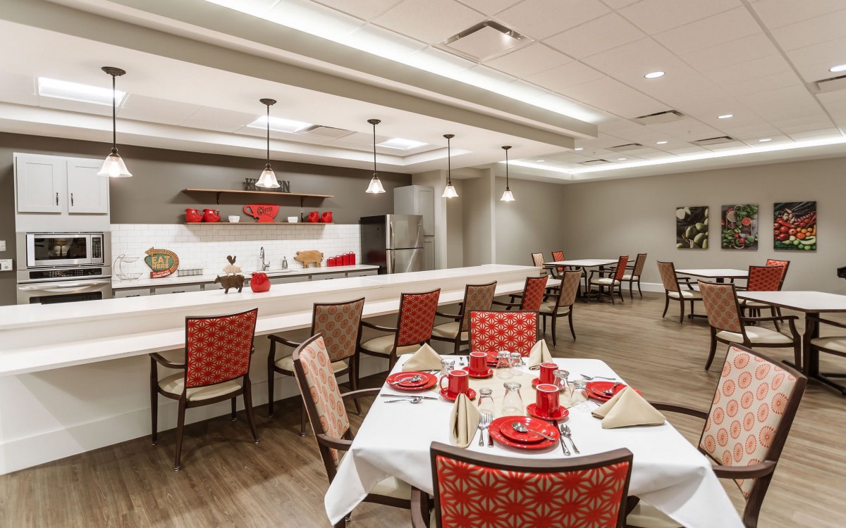 A well-decorated dining area with red-themed decor and modern lighting.