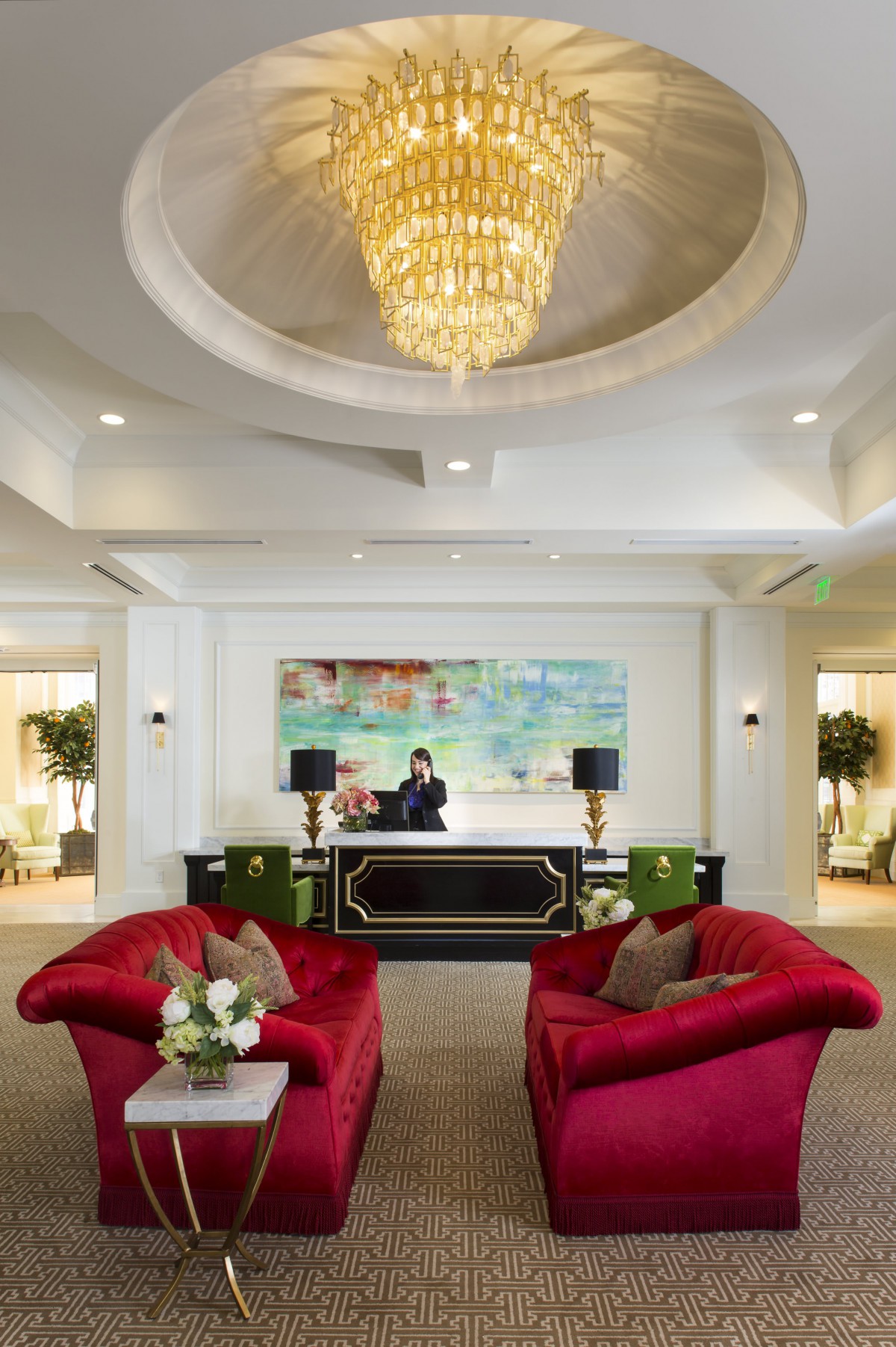 Luxurious hotel lobby with elegant chandelier and comfortable seating.