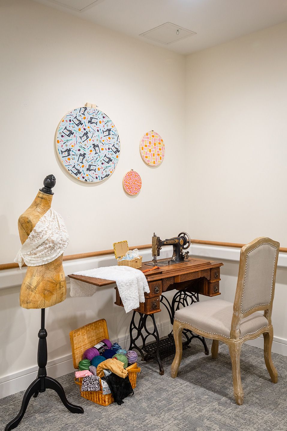 A cozy sewing room featuring a vintage sewing machine and mannequin.