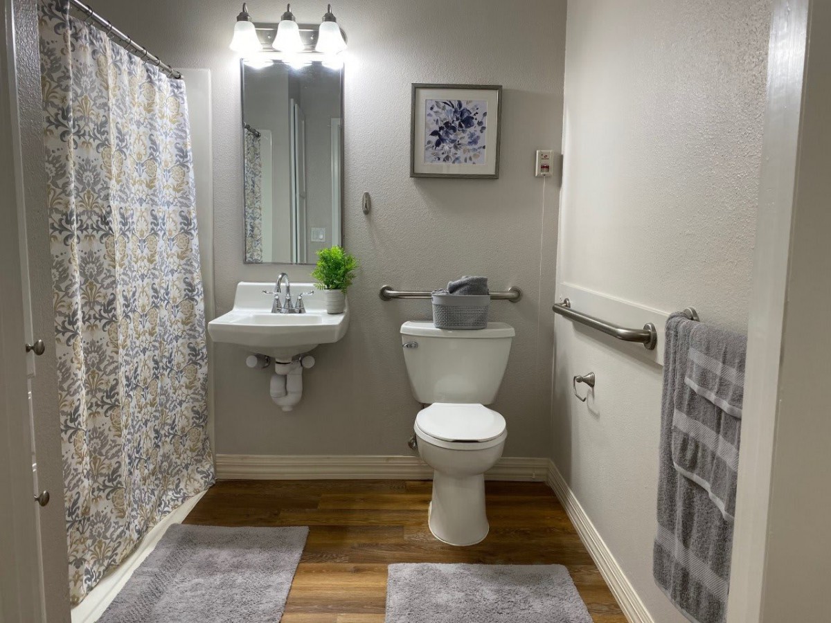 A well-organized bathroom with modern fixtures and simple decor.