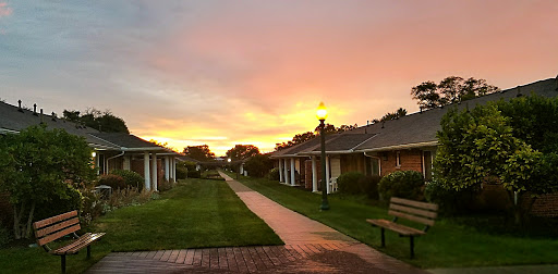 A serene sunset over a cozy pathway lined with charming buildings.