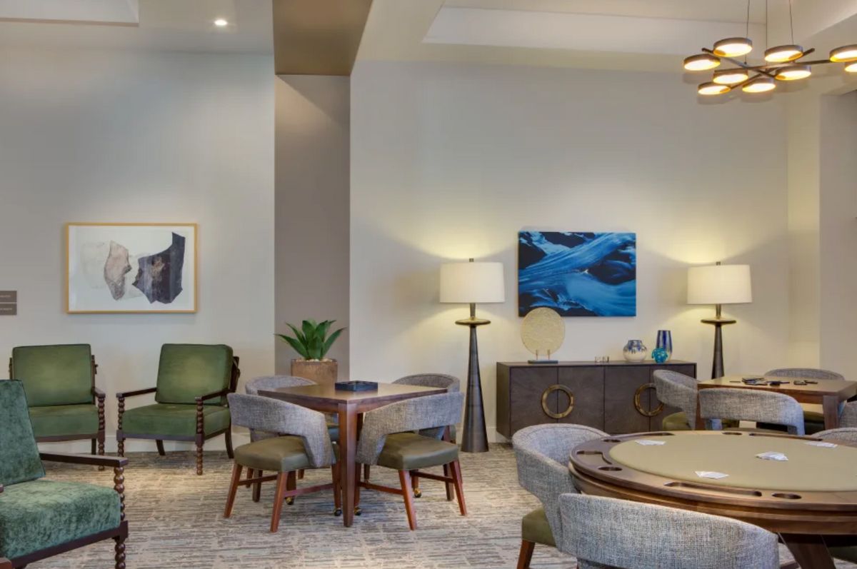 A modern living room with stylish furniture, artwork, and ambient lighting.