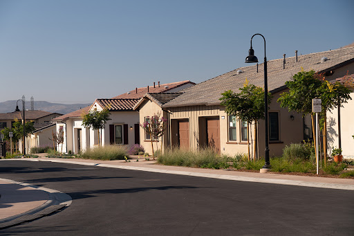 A row of charming houses along a quiet street, showcasing suburban architecture.