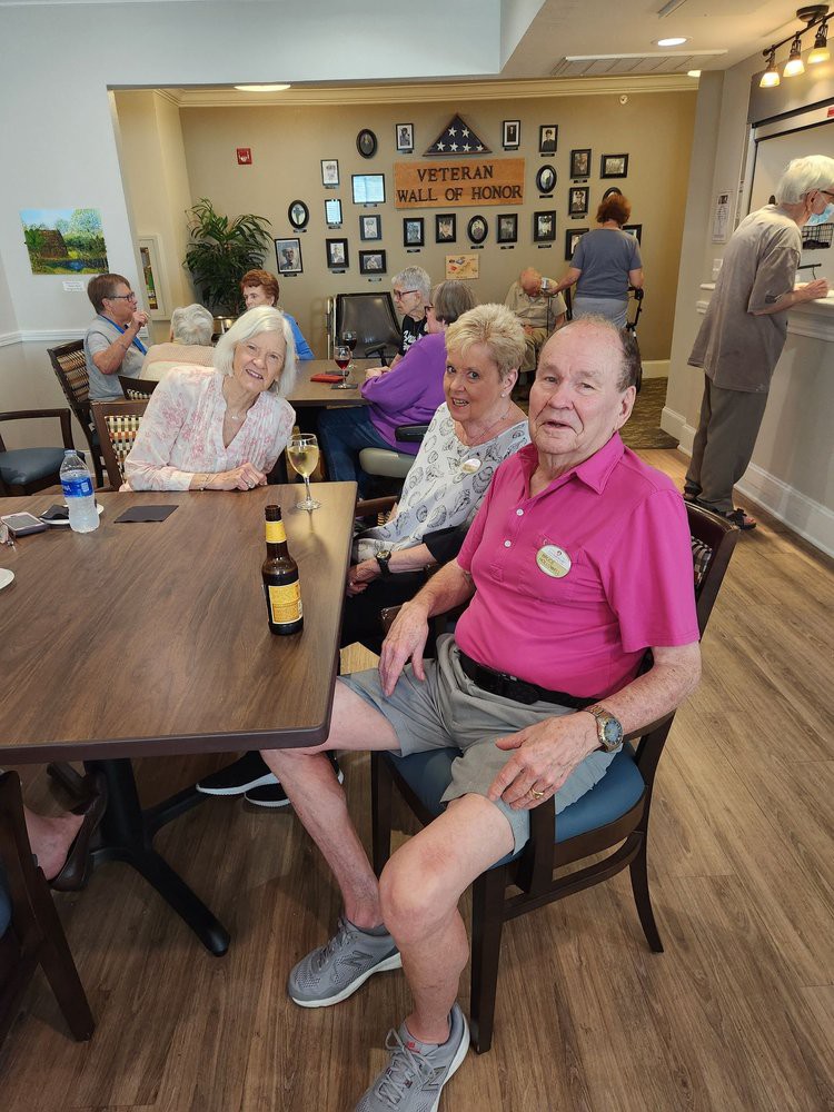 A group of seniors enjoying a social gathering in a casual indoor setting.