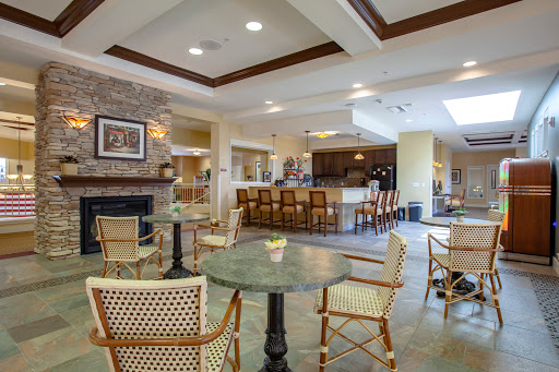 A cozy and inviting lounge area featuring a fireplace and a bar, perfect for social gatherings.