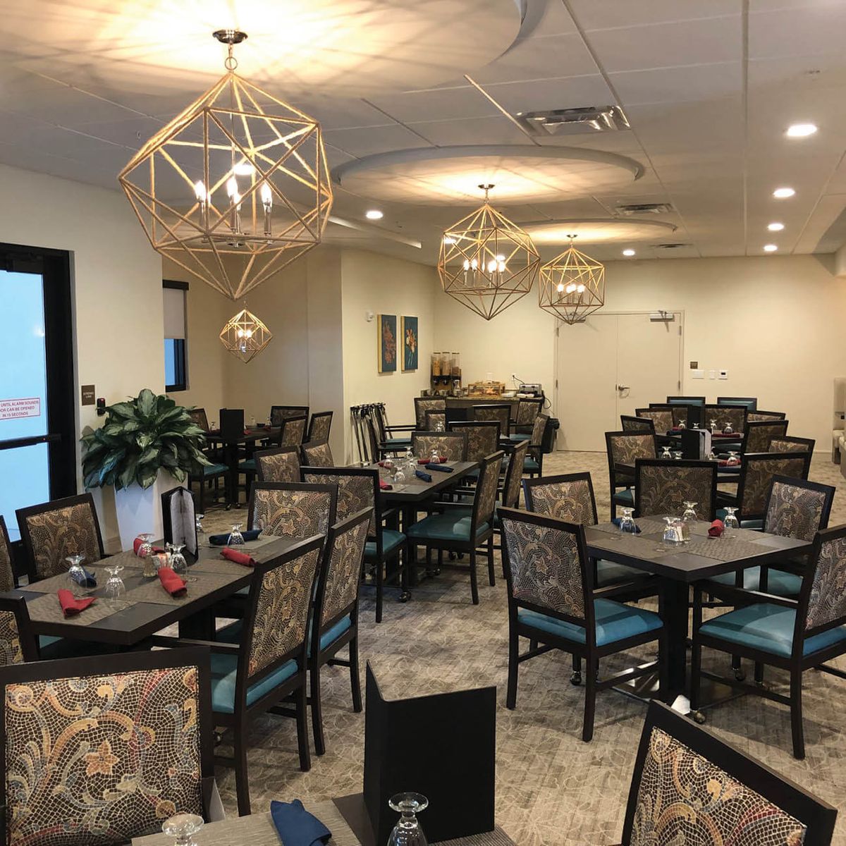 An elegant dining area with neatly arranged tables and stylish lighting fixtures.