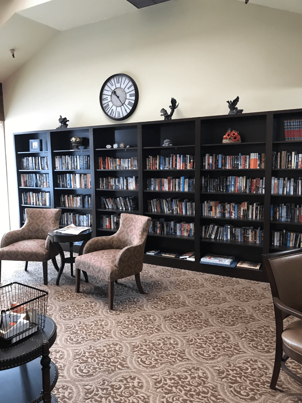 A cozy library corner with bookshelves and comfortable seating.