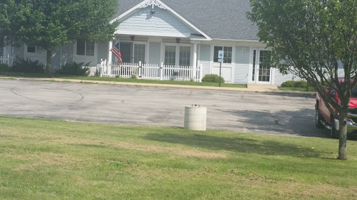 A peaceful residential setting with a house and a flag in the foreground.