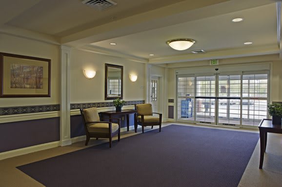 A spacious lobby with seating and large windows.