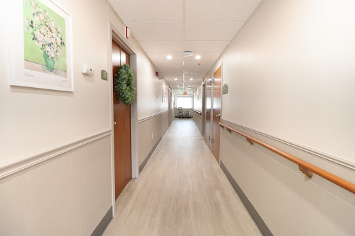 A well-lit and clean hallway with doors on either side.