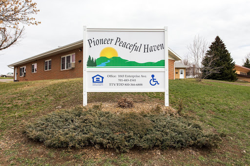 Sign for Pioneer Peaceful Haven, indicating a community space surrounded by nature.