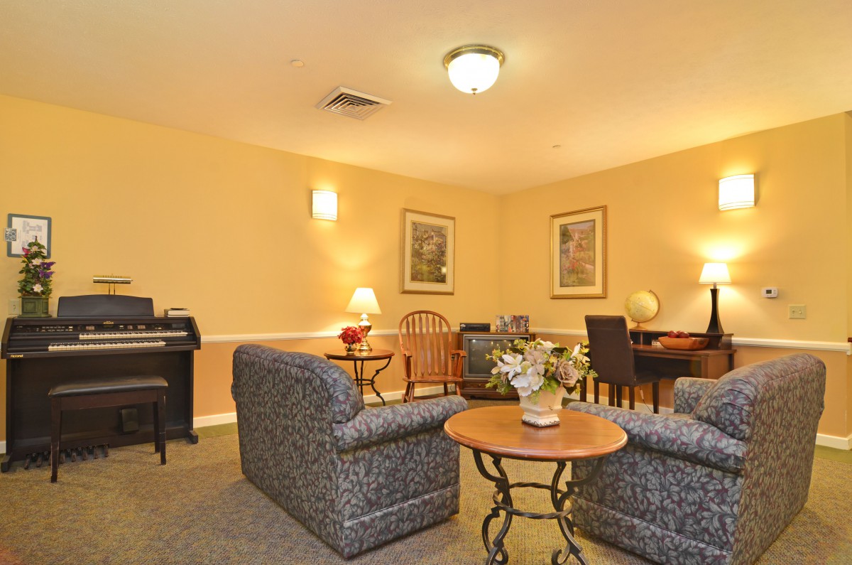 A cozy living room with comfortable seating and warm lighting.