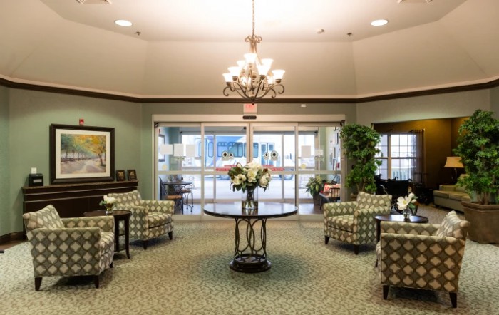 A well-decorated lobby with comfortable seating and a central table adorned with flowers.