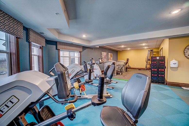 A well-equipped gym with various exercise machines and cardio equipment.