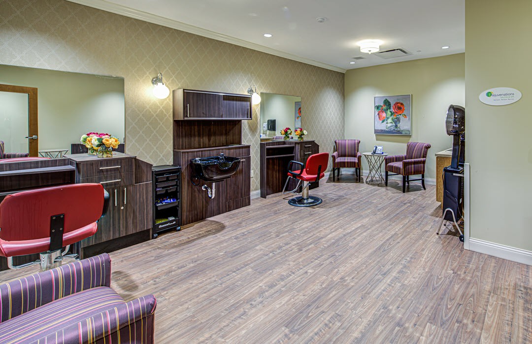 Modern hair salon interior with styling stations and comfortable chairs.