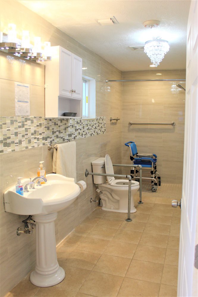 An accessible bathroom equipped with grab bars and a wheelchair-accessible toilet.