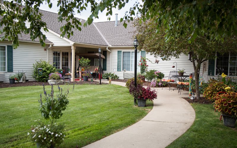 A charming house with a well-maintained garden and pathway.