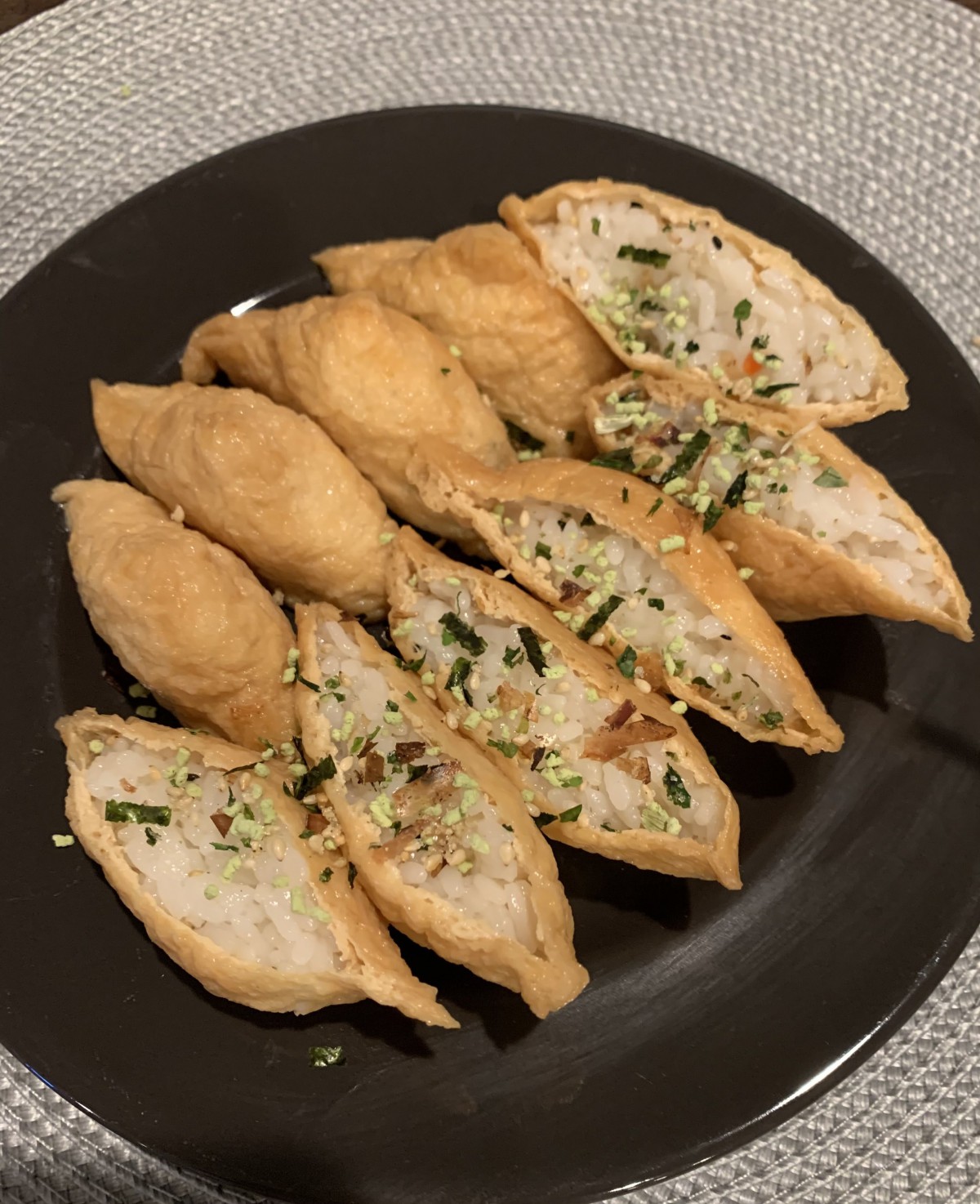 A plate of fried stuffed pastries garnished with herbs.