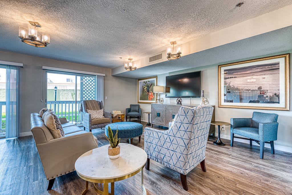 A stylish and modern living room with comfortable seating, a large TV, and contemporary artwork.