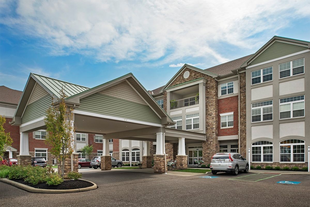 A modern residential building with a covered entrance.