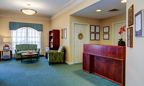 A welcoming office lobby with a reception desk and seating area.