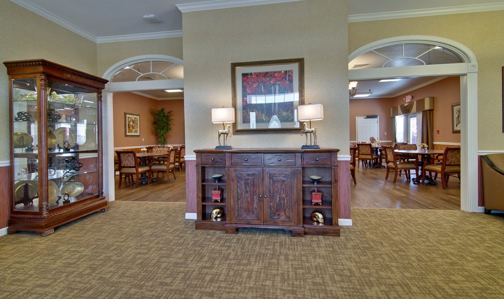 A cozy interior with a wooden cabinet and dining area in the background.