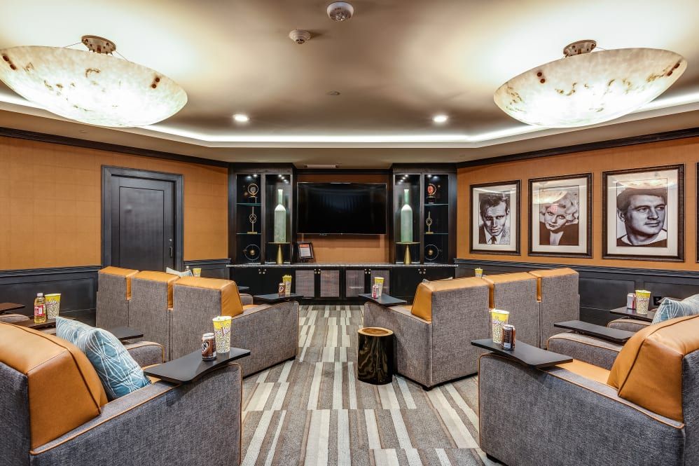A luxurious home theater with comfortable seating and a large screen.