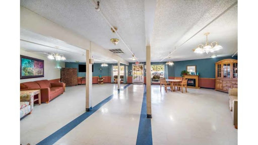An open community lounge area featuring comfortable seating and bright lighting, suitable for gatherings or activities.