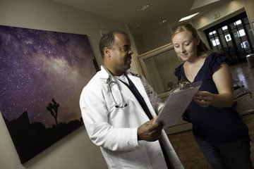 A doctor discussing medical information with a patient in a healthcare setting.
