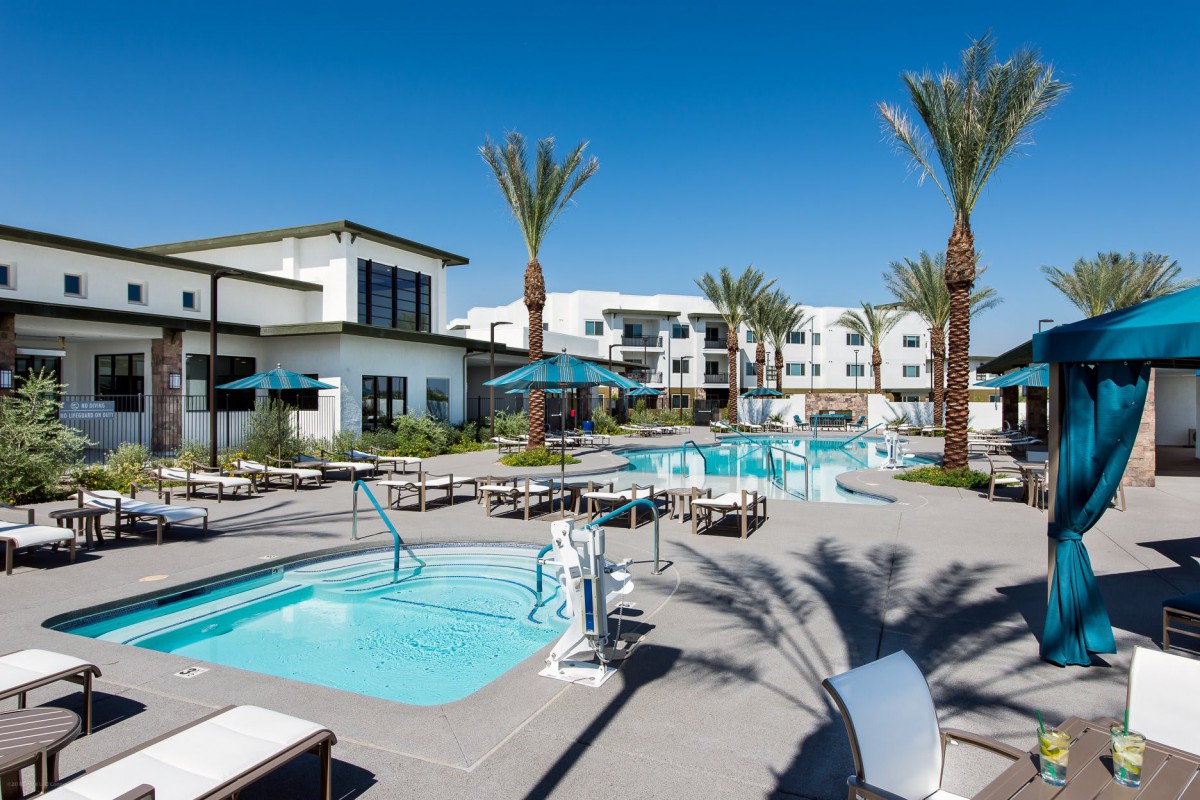 A luxurious resort featuring multiple swimming pools and surrounded by palm trees.