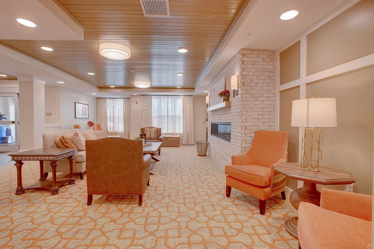 A cozy and elegantly designed living room with comfortable seating and warm lighting.