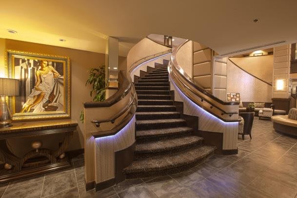 Luxurious curved staircase in a modern hotel lobby.