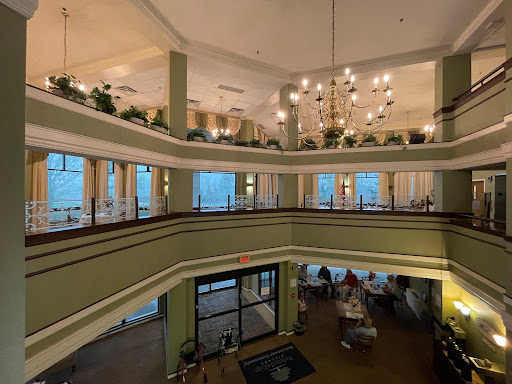 A beautifully designed multi-level lobby with elegant lighting and lush plants.