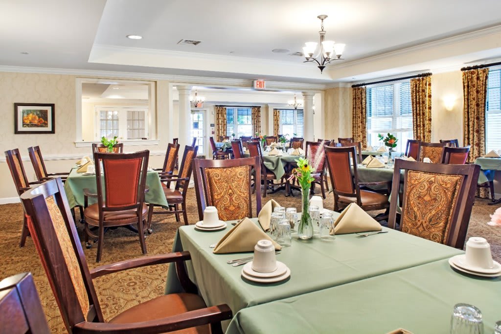 An elegant dining area with neatly arranged tables and chairs, ready for guests.