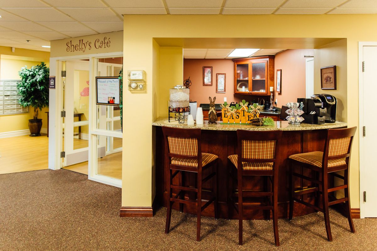 A cozy cafe interior with a seating area and counter.
