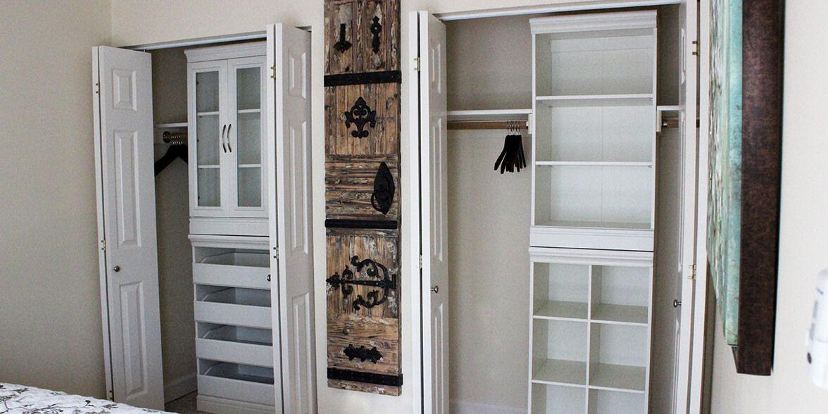 A modern interior featuring open closet doors with shelves and decorative artwork on the wall.