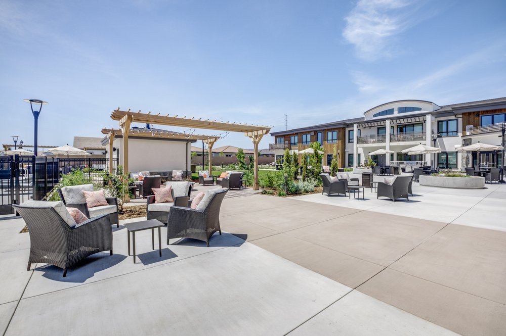 Modern outdoor patio area with comfortable seating and a pergola.