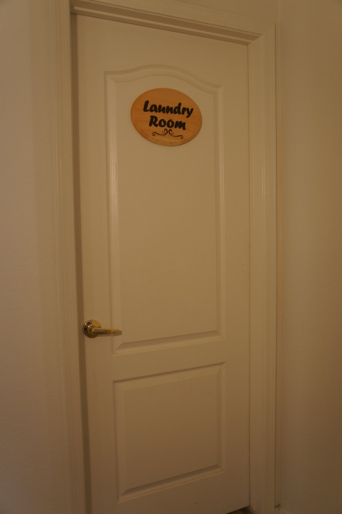 A closed door with a 'Laundry Room' sign.