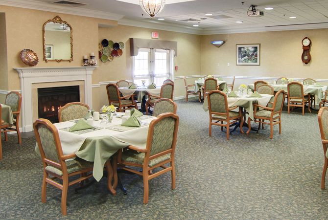 A cozy dining area with neatly arranged tables and chairs, featuring a warm and inviting decor.