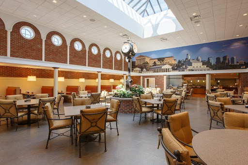 A spacious and elegantly designed dining area featuring comfortable seating and abundant natural light.