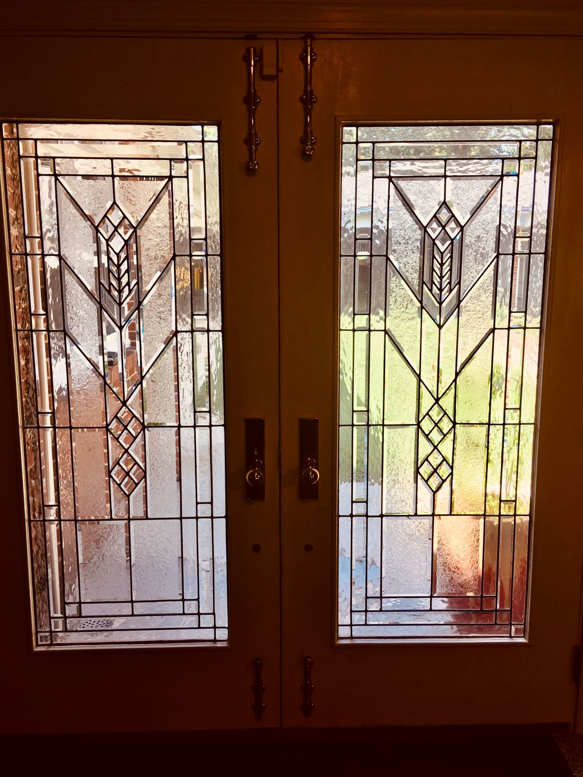 A pair of doors featuring intricate stained glass with geometric patterns.