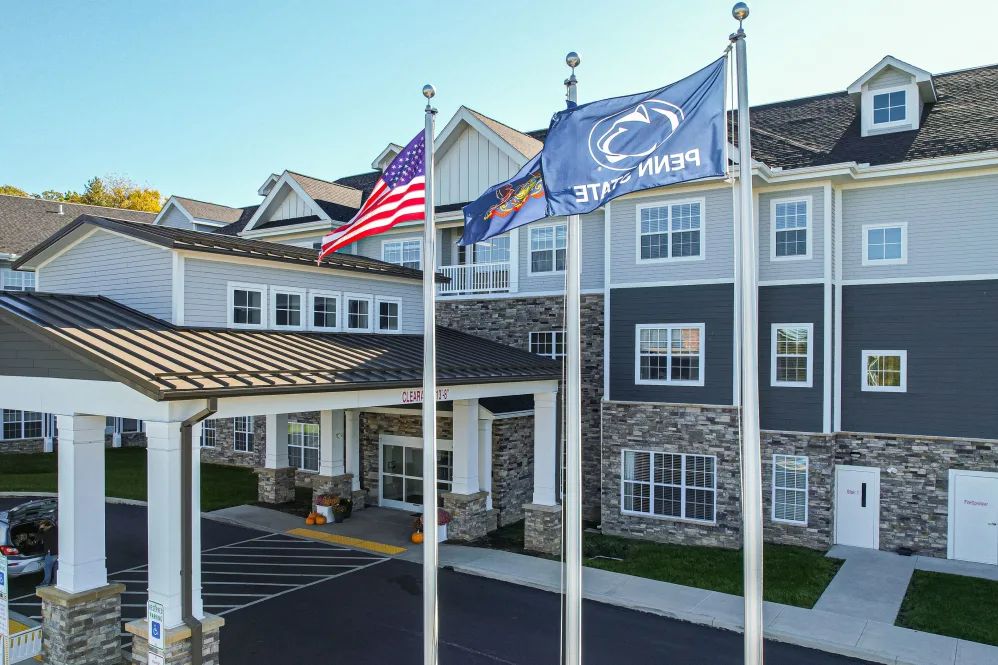 A hotel entrance with flags displayed outside.